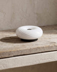 Striped Halo Touch Lamp on a rustic wooden shelf