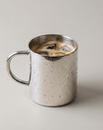 Double-Wall Glossy Stainless Steel Cup filled with iced coffee, showing reflections