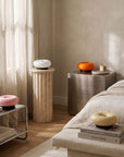 Orange and pink Halo Touch Lamps on steel side tables in a living room