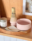 KASUMI Matcha Ritual Set in pink on a wooden tray with matcha tin