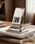 Timeless rotating desk date keeper with mechanical page-turning design by LoveÉcru