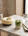Cream Halo Touch Lamp on a table with a glass of matcha