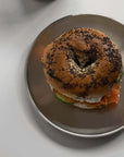 Stainless steel plate from the Set of Six with a filled bagel sandwich