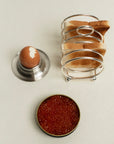 Stainless Steel Egg Cup with an egg beside a toast rack and a dish of caviar