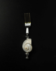 Shoreline fork with a natural shell handle on a black background