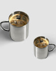 Milano Duo Set stainless steel double-walled cups with coffee, showcasing modern elegance and functionality.