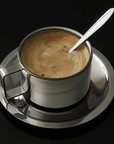 Italian style steel latte coffee cup with saucer and spoon, featuring double-layered design for thermal insulation, on a black background.