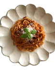 Elegant Rinka Plate 24cm with pasta topping, showcasing Japanese craftsmanship and porcelain design.