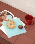 Puzzle Pop Chopping Boards on a kitchen counter with a bagel and a red mug