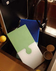 Blue and green Puzzle Pop Chopping Boards in a kitchen sink