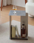 Industrial Minimalist Steel Side Table beside a sofa with a glass and books