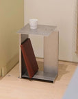 Industrial Minimalist Steel Side Table with a cup on top and a book on the lower shelf