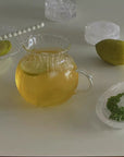 Clair Pitcher with lemonade beside a lemon and parsley