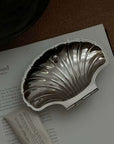 Vintage Shell-Shaped Silver Trinket Case on a book, from the Spring Bundle