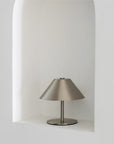 Atelier Halo Lamp in a white alcove, brushed stainless steel