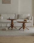 Stylish living room featuring two wooden Clown Tables with playful, block-inspired design, placed in front of a beige sofa.