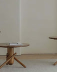 Sleek and playful wooden Clown Tables in three sizes on a minimalist rug, perfect for versatile and imaginative decor.