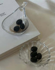 Liora Hand-Blown Glass Scoop Bowl with olives beside the Clara Glass Shell Dish