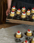 A tray of Elegant Dessert Cups with cream puddings topped with strawberries