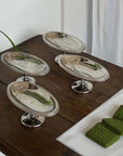 Three Elegant Dessert Pedestal Stands on a wooden table with small cakes