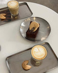 Minimalism Stainless Steel Serving Trays with coffee, cake and a cappuccino on a white table