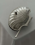 Vintage Shell-Shaped Silver Trinket Case on a white cloth, closed