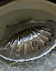 Vintage Shell-Shaped Silver Trinket Case open in a ceramic bowl