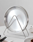 Set of Six Stainless Steel Plates standing upright in the wire stand, front view
