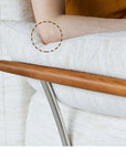 Close-up of arm resting on cushioned Nozomi Banca Sofa with wooden frame, highlighting comfort and design details.