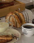 Elegant 304 stainless steel toast holder with six slots, keeping breakfast toast warm and crisp. Sophisticated kitchen accessory.