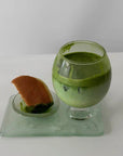 Lumi Stem Glass with matcha latte on a glass tray with a pastry