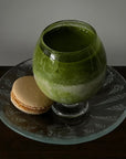 Lumi Stem Glass with matcha on a glass saucer beside macarons
