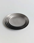 Hakone Plates nested in a stack of four, matte finish, side view