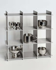Stello Countertop Grid Shelf 3×3 holding stainless steel cups and bowls