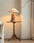Custom-crafted wooden lamp on elegant side table in cozy living room setting.