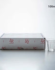 Zinc coffee glass cup with ridged design next to branded packaging, 100ml capacity, made in France.