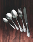 Vintage INOX Baguette Classic Series Cutlery set featuring a knife, fork, and spoons with elegant, timeless design on a wooden surface.