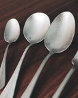 Vintage Inox Baguette Classic Series cutlery spoons with elegant design on a wooden table.