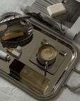Spring Bundle Signature tray with a cappuccino, shell case and magazines, angled view
