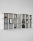 Two Stello Countertop Grid Shelves side by side on a wall with candles and jars