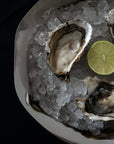 Close-up of oysters on ice in the Sculpted Stainless Steel Bowl