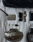 LoveÉcru Vintage Metal Comb laid out with a shell trinket case, watch, lipstick and perfume