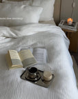 Minimalism Stainless Steel Serving Tray with a coffee cup on a bed with a book