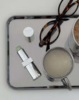 Minimalism Stainless Steel Serving Tray used on a vanity with glasses and skincare