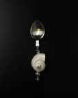 Shoreline spoon with a natural shell handle on a black background