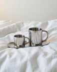 Milano Duo Set with coffee in both cups on a rumpled white bed