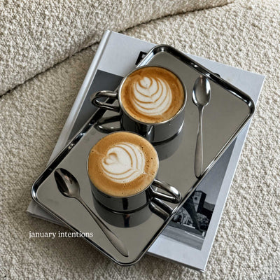 Minimalism Stainless Steel Serving Tray with a latte and spoon on a stack of books