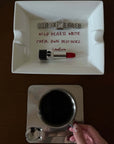 Wild Hearts ceramic tray with a lipstick next to a hand holding a coffee cup