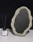 Nordic cloud-shaped vanity mirror with beige frame, alongside Byredo Super Cedar diffuser, size 27x20cm, free shipping.