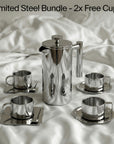 Limited Steel Bundle with French press and four steel cups on a white bed